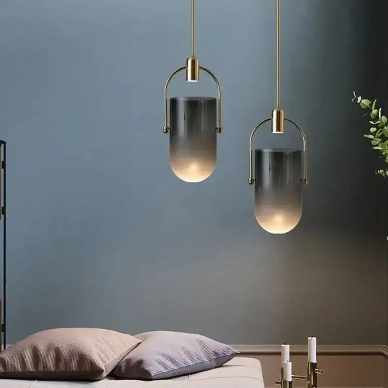 Two modern pendant lights with brass metal frames and gradient gray glass shades from decorbites bucket chandelier