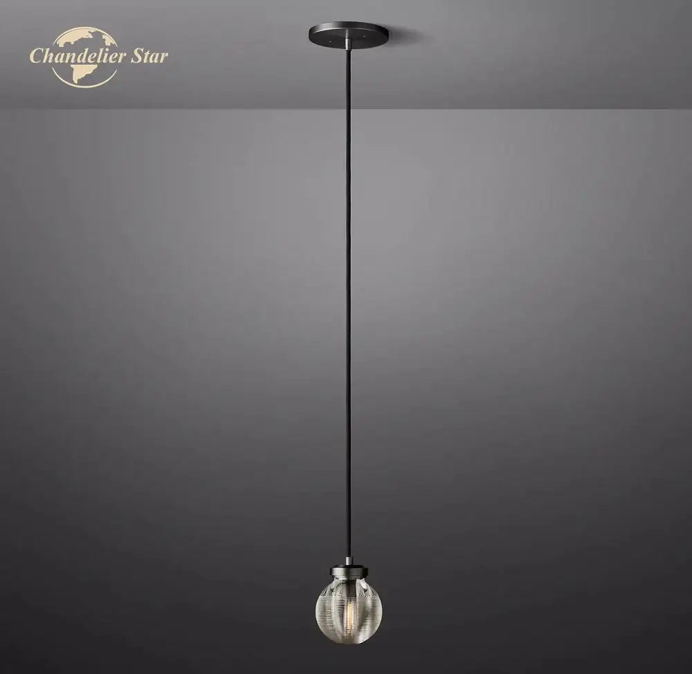 A sleek black cord suspends a spherical glass decorbites crystal pearl pendant light with brushed metal finish