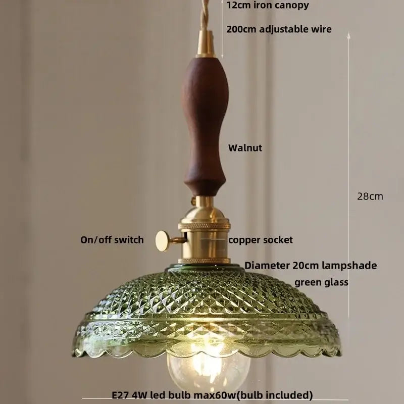 A vintage-style pendant lamp with dark walnut iron canopy brass hardware and ornate green cube amber glass shade