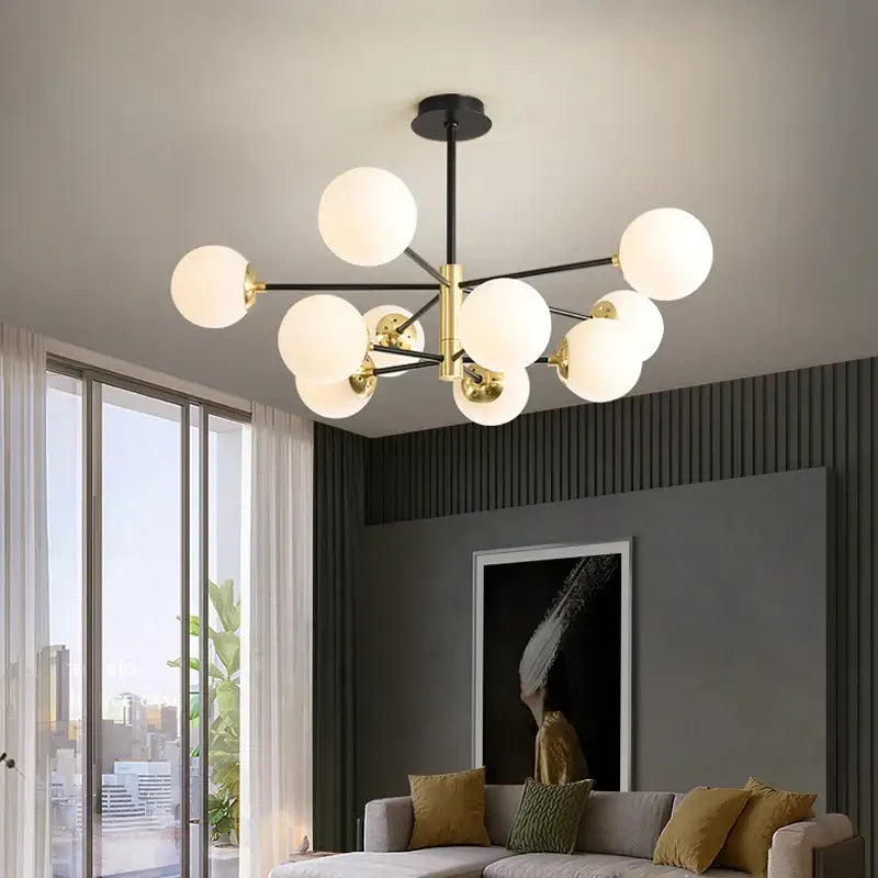 Modern brass decorbites glass ball led chandelier with black rod and gold accents featuring frosted glass globe bulbs
