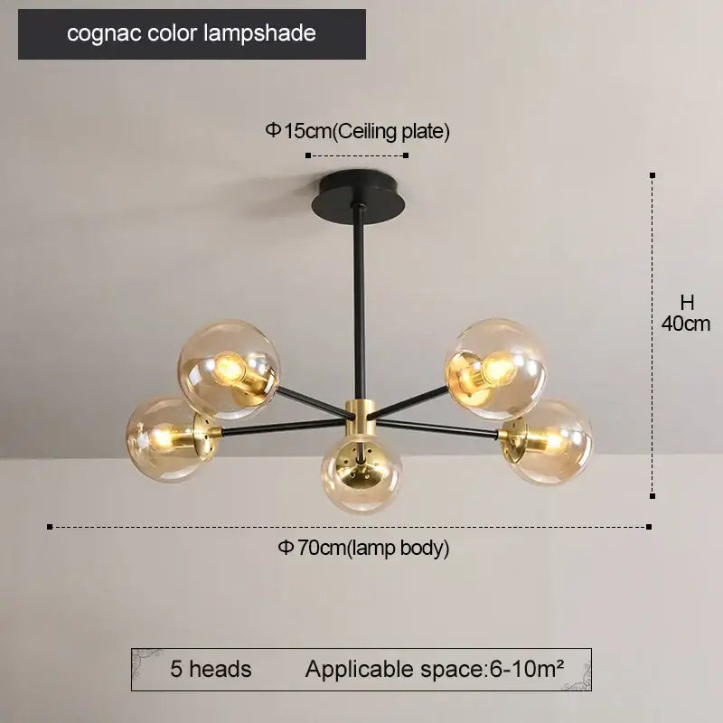 Modern brass decorbites glass ball led chandelier featuring cognac-colored glass with black and brass accents for kitchen lighting