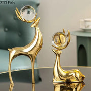 Modern brass deer statue desk ornament with crystal orbs on antlers featuring one standing and one reclining figurine