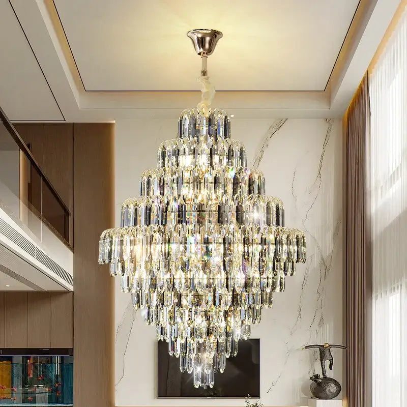 Modern brass designer led crystal chandelier featuring cascading clear and silver glass prisms for dining room decorbites designer led