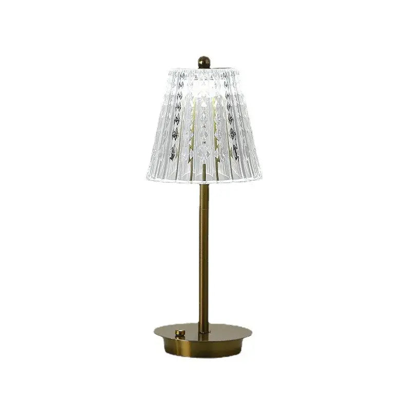 Modern brass diamond touch desk lamp with clear faceted crystal lampshade and gold-toned metal base and stem