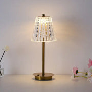 A delicate modern brass diamond touch desk lamp with a faceted crystal shade for bedroom lighting