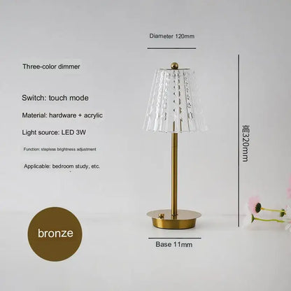 A sleek modern brass diamond touch desk lamp with a bronze base fluted acrylic shade and led lighting for bedroom use