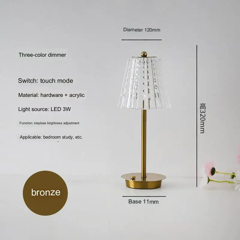 A sleek modern brass diamond touch desk lamp with a bronze base fluted acrylic shade and led lighting for bedroom use