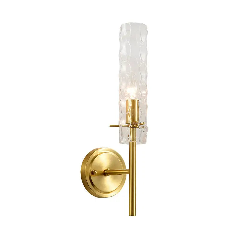 Modern brass dimpled blown glass wall light with textured translucent gold-toned blown glass cylinder shade for bedroom
