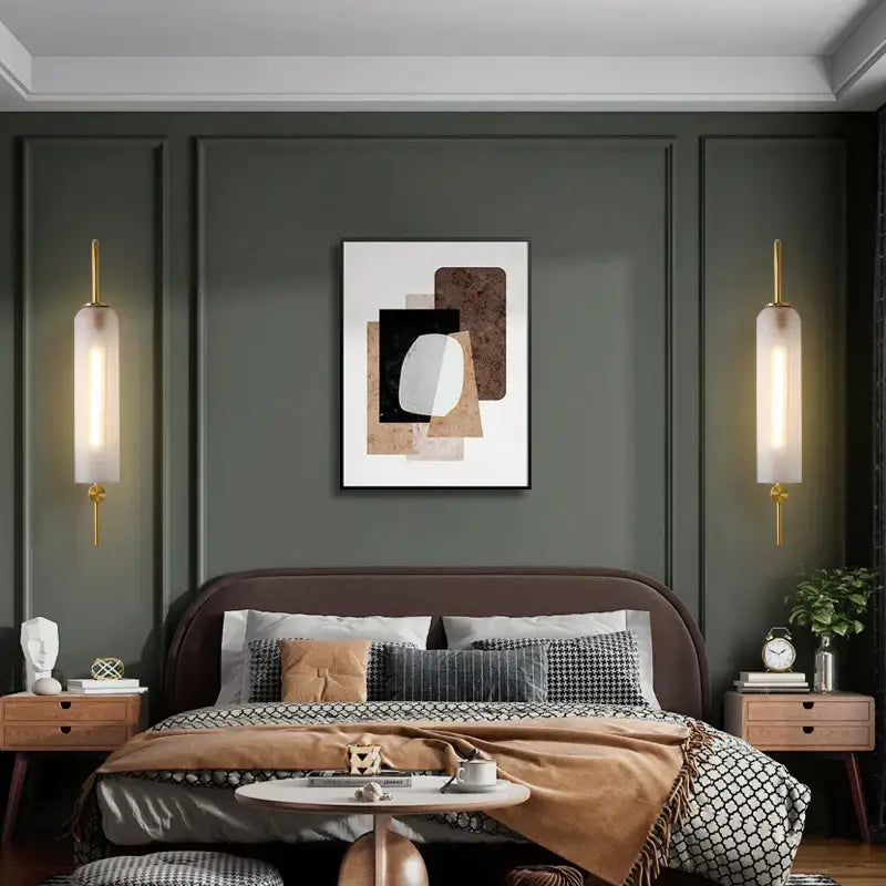Abstract geometric artwork with layered black white beige and brown shapes complements modern brass e27 glass wall light bedroom sconce