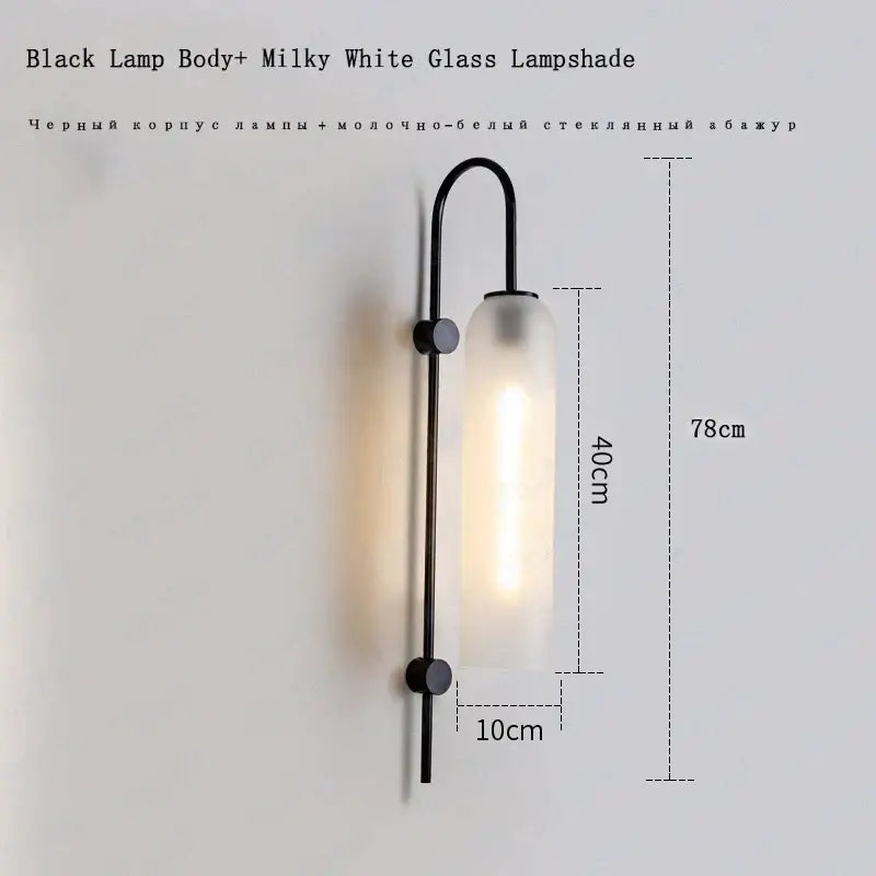 Black metal wall light with e27 glass wall light featuring a tall cylindrical milky white glass lampshade for bedroom use