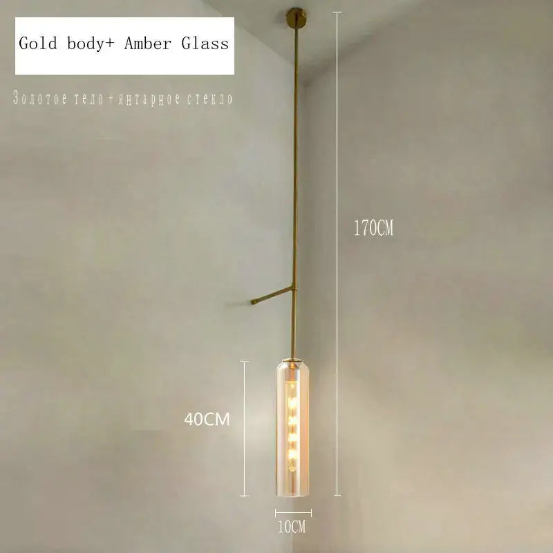 Modern brass e27 glass wall light with gold-toned metal frame and amber glass cylinder for bedroom sconce lighting