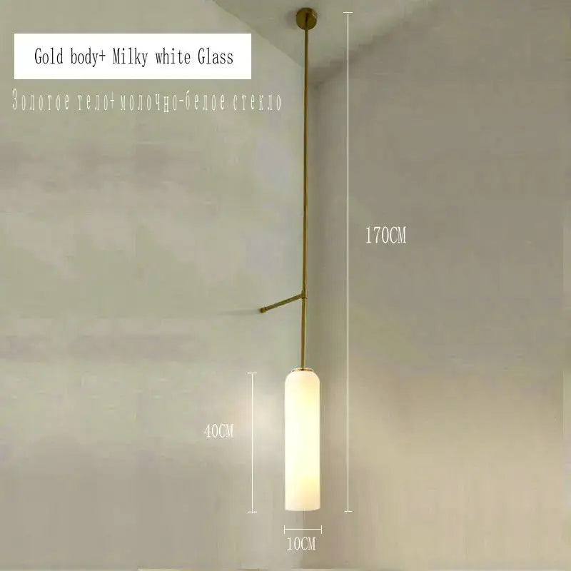 Modern brass e27 glass wall light with gold-toned metal frame and cylindrical milky white glass shade for bedroom use