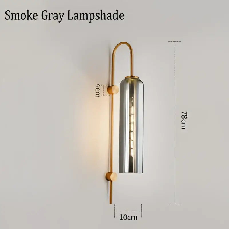 Modern brass e27 glass wall light with smoke gray cylindrical lampshade and brass-finished curved metal arm