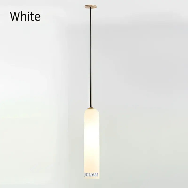 Modern brass e27 glass wall light with white cylindrical frosted glass shade and black hanging cord for bedroom sconce