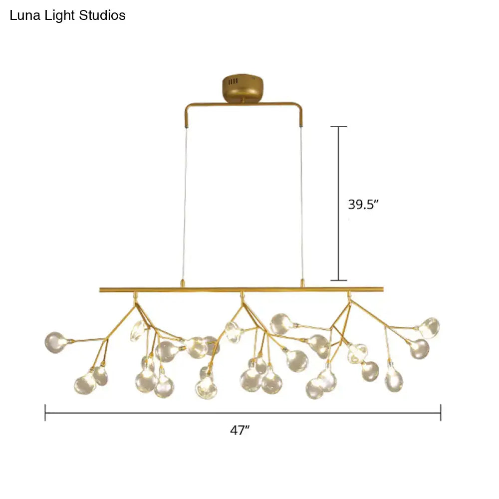 Gold-toned decorbites™ 27-bulb island light with brass finish and clear glass globe bulbs in minimalist branch design 220v-240v