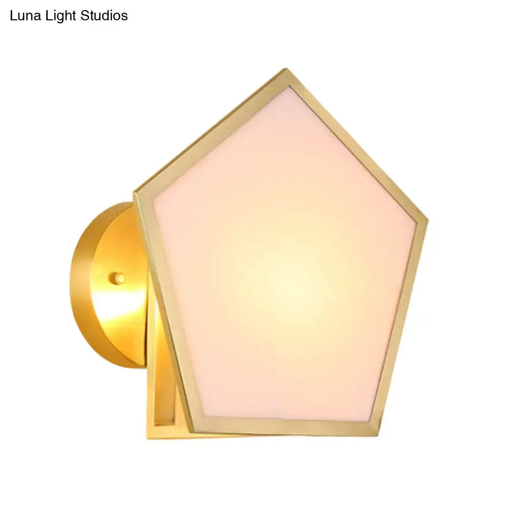 Modern brass finish pentagon wall lamp with a gold-finished metal wall and soft pink frosted glass shade