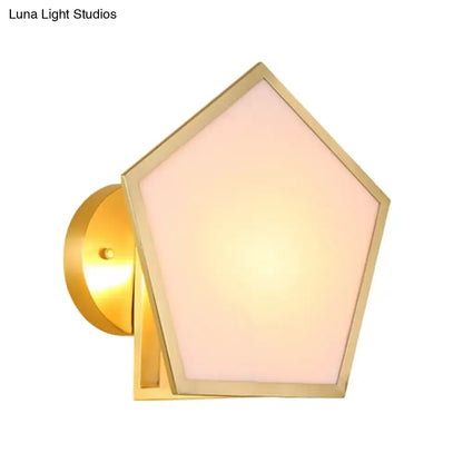 Modern brass finish pentagon wall lamp with a gold-finished metal wall and soft pink frosted glass shade