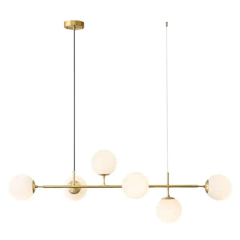Modern brass pendant light with five frosted golden glass ball shades for dining room illumination