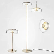 Modern brass floor lamp with clear glass lampshade featuring decorbites circular glass design for living room decor
