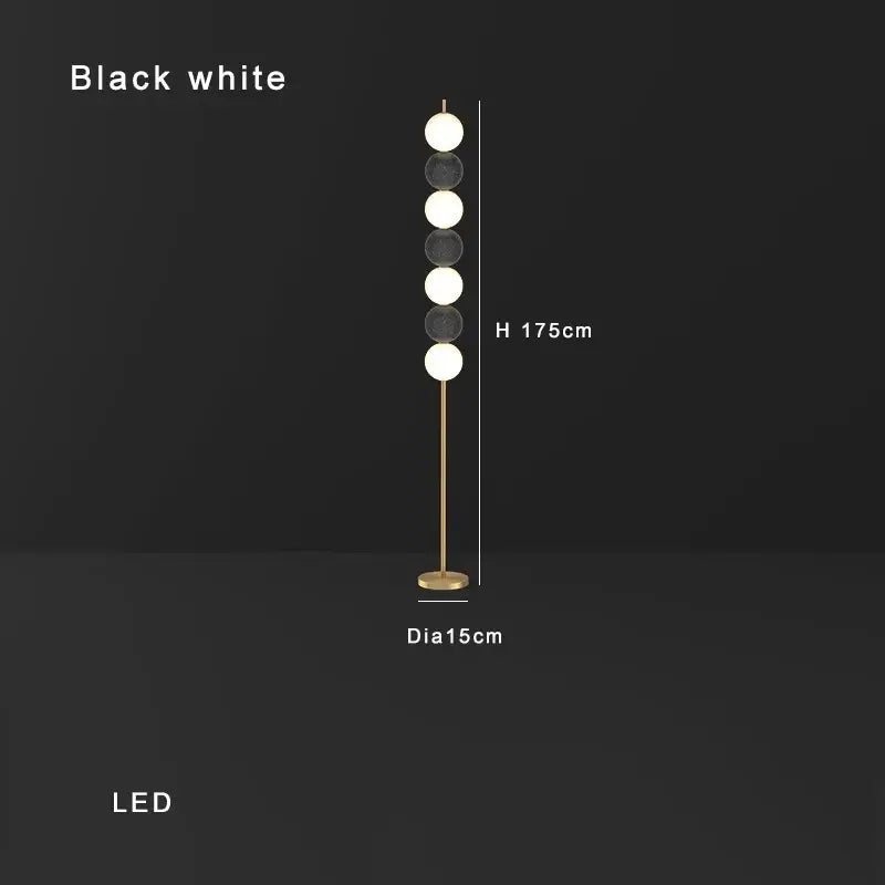 Modern brass floor lamp with five black and white led spheres on a slender gold-toned pole for decorbites brass floor lamp decor