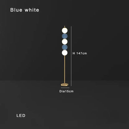 Modern brass floor lamp with six spherical white and blue shades on a slender gold-toned brass floor lamp stand for decorbites decor
