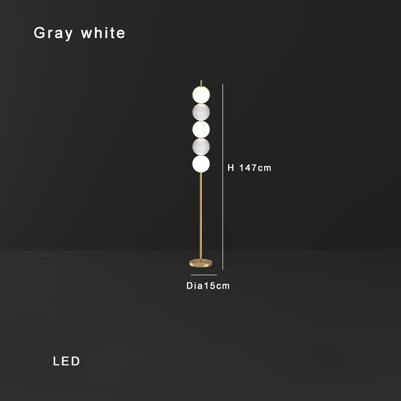 Modern brass floor lamp with six gray and white glass spheres on a slender gold-toned stand for living room decorbites brass floor lamp
