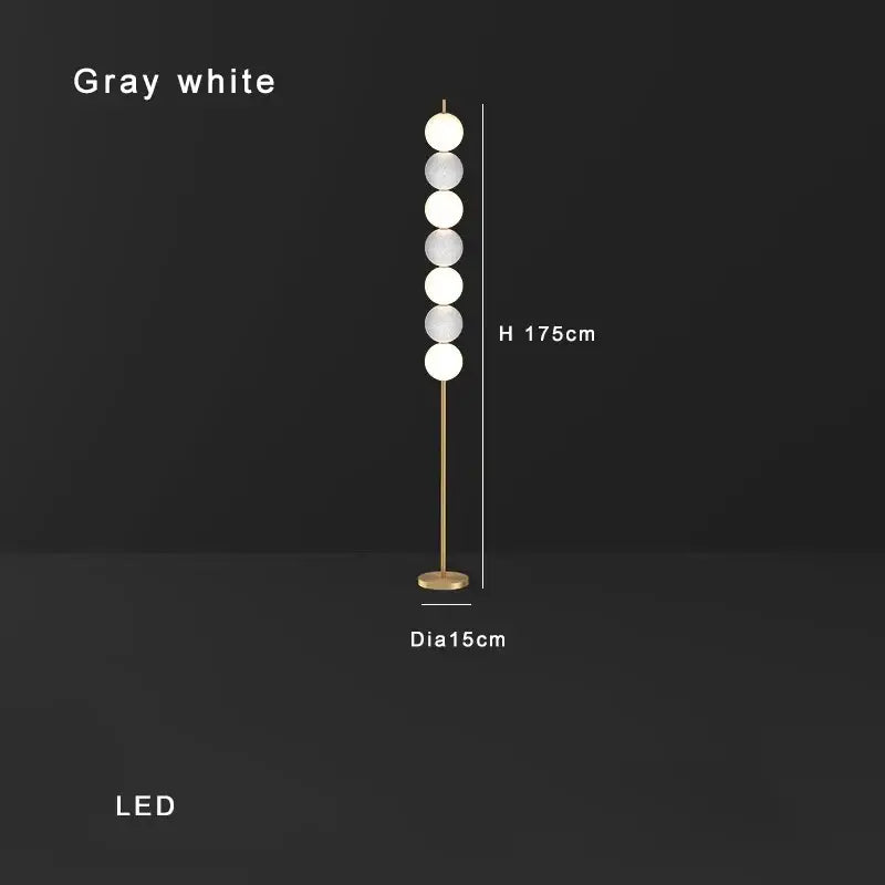 Modern brass floor lamp with six gray-white glass spheres and slender gold-toned stand for living room decorbites brass floor lamp