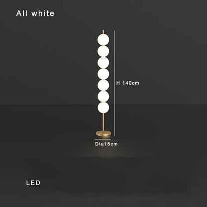 Modern brass floor lamp with six white glass spheres on a slender stand ideal for living room decorbites brass floor lamp