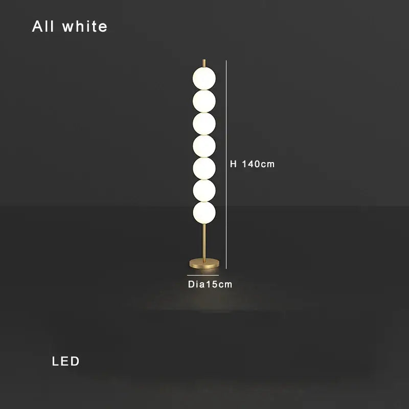 Modern brass floor lamp with six white glass spheres on a slender stand ideal for living room decorbites brass floor lamp