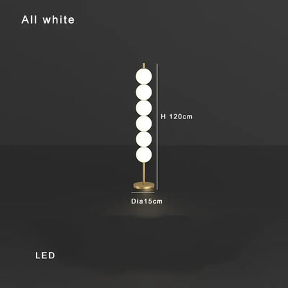 Modern brass floor lamp with five white glass spheres on a slender stand for elegant living room decorbites brass floor lamp