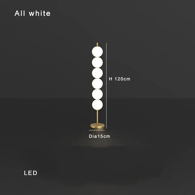 Modern brass floor lamp with five white glass spheres on a slender stand for elegant living room decorbites brass floor lamp