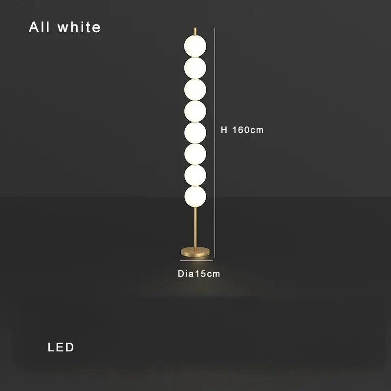 Modern brass floor lamp with seven white spherical bulbs and gold-toned decorbites brass floor lamp base