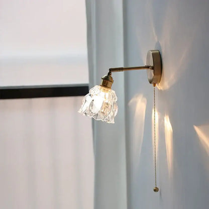 Modern brass floral wall sconce with faceted clear glass shade and pull chain by decorbites clear glass decor