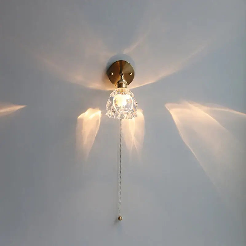 Modern brass floral clear glass wall sconce with brass finish and faceted clear glass shade for warm stair light decorbites clear glass