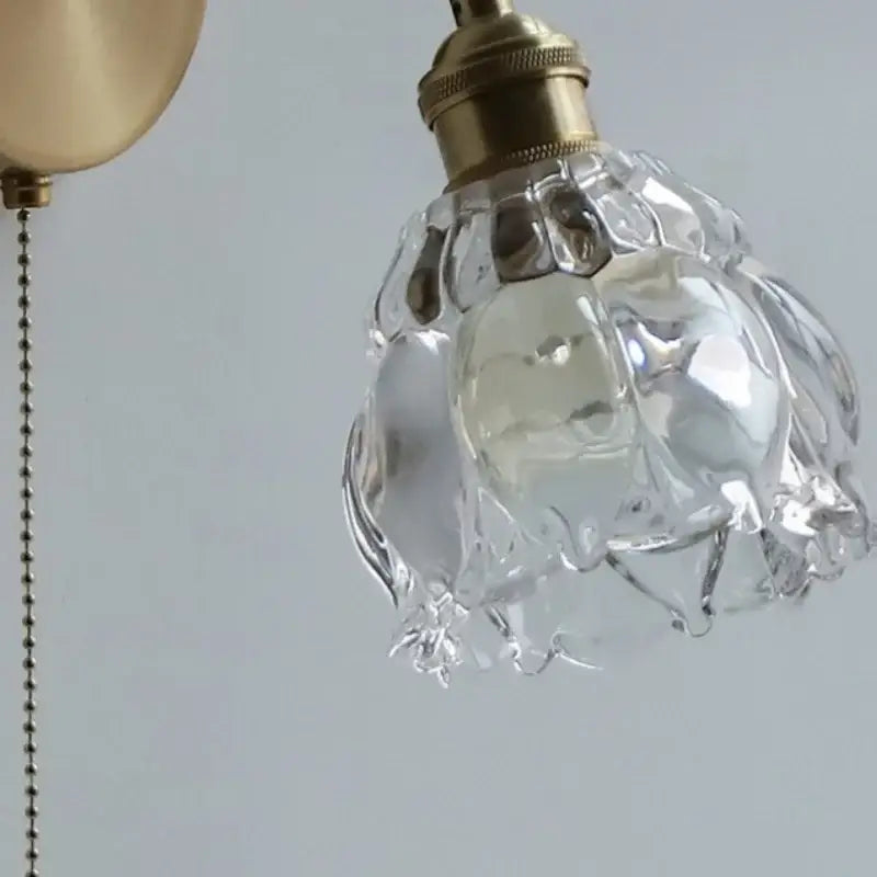 Modern brass flower glass base led wall sconce with clear faceted glass shade and brass finished metal fixture for bedroom decorbites wall sconce