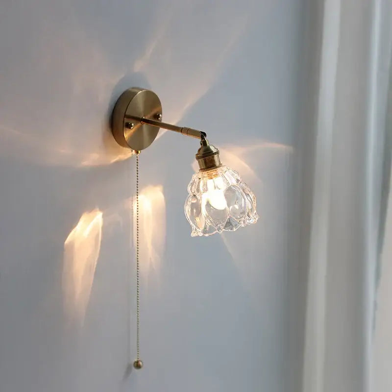 Modern brass wall sconce with a clear faceted glass base led shade and adjustable arm for bedroom decorbites glass base lighting
