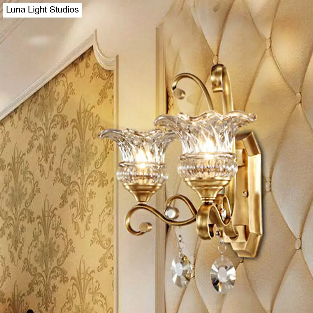 Modern brass flower sconce wall lamp with gold-toned finish and crystal shades for bedroom light fixture