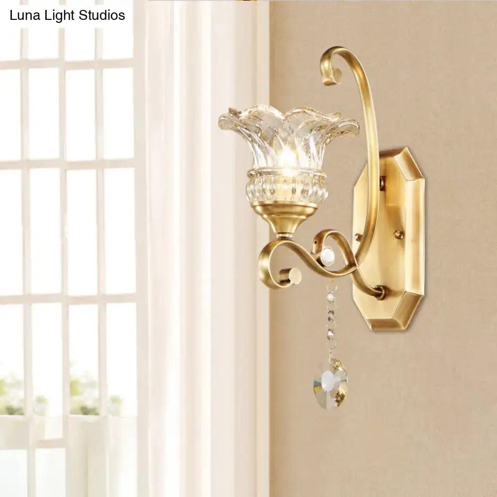 Modern brass flower sconce wall lamp with gold-toned metal, faceted glass shade, and crystal pendant light fixture