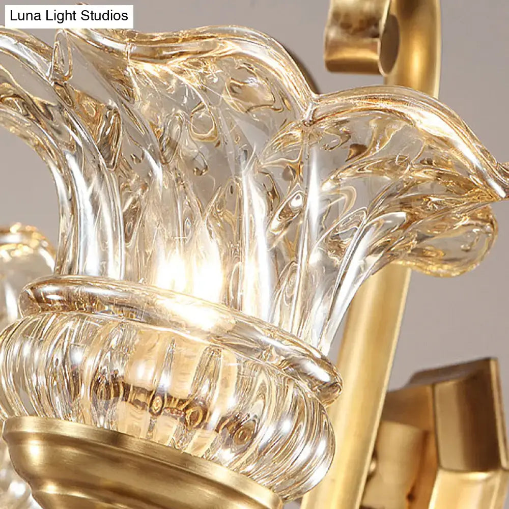 Golden brass flower sconce wall lamp with clear sculpted glass shades featuring intricate leaf patterns light fixture