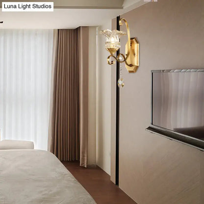 Modern brass flower sconce wall lamp with gold tone crystal glass shade and dangling crystal accent light fixture
