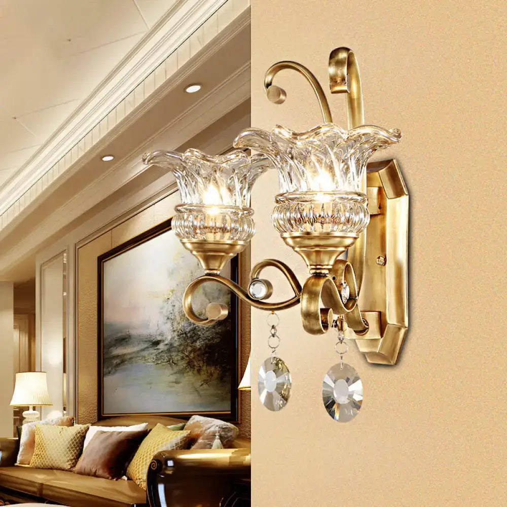 Modern brass flower sconce wall lamp with gold-toned finish crystal glass shades and dangling faceted crystals light fixture