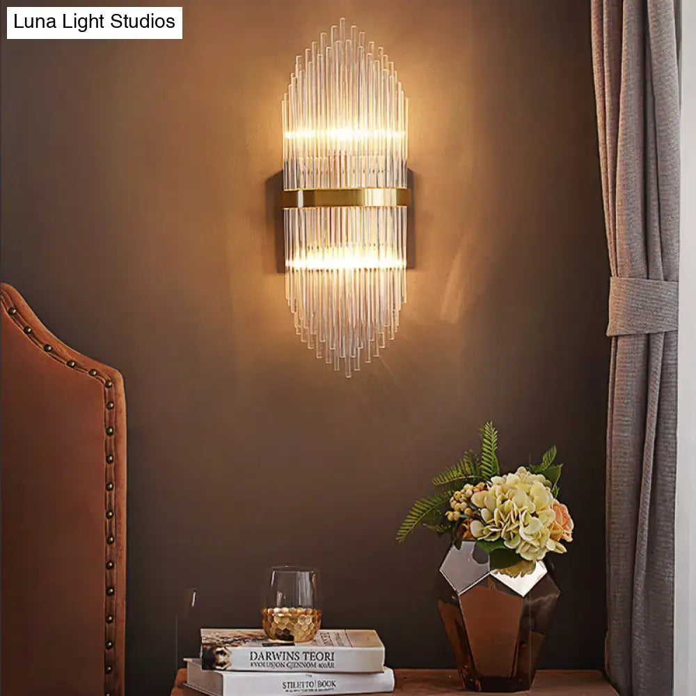 Modern brass wall sconce with fluted glass shade and gold-toned metal accents direct wired electric bedroom light
