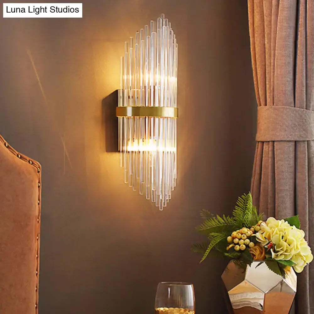 Modern brass wall sconce with fluted glass shade and polished gold frame direct wired electric bedroom light