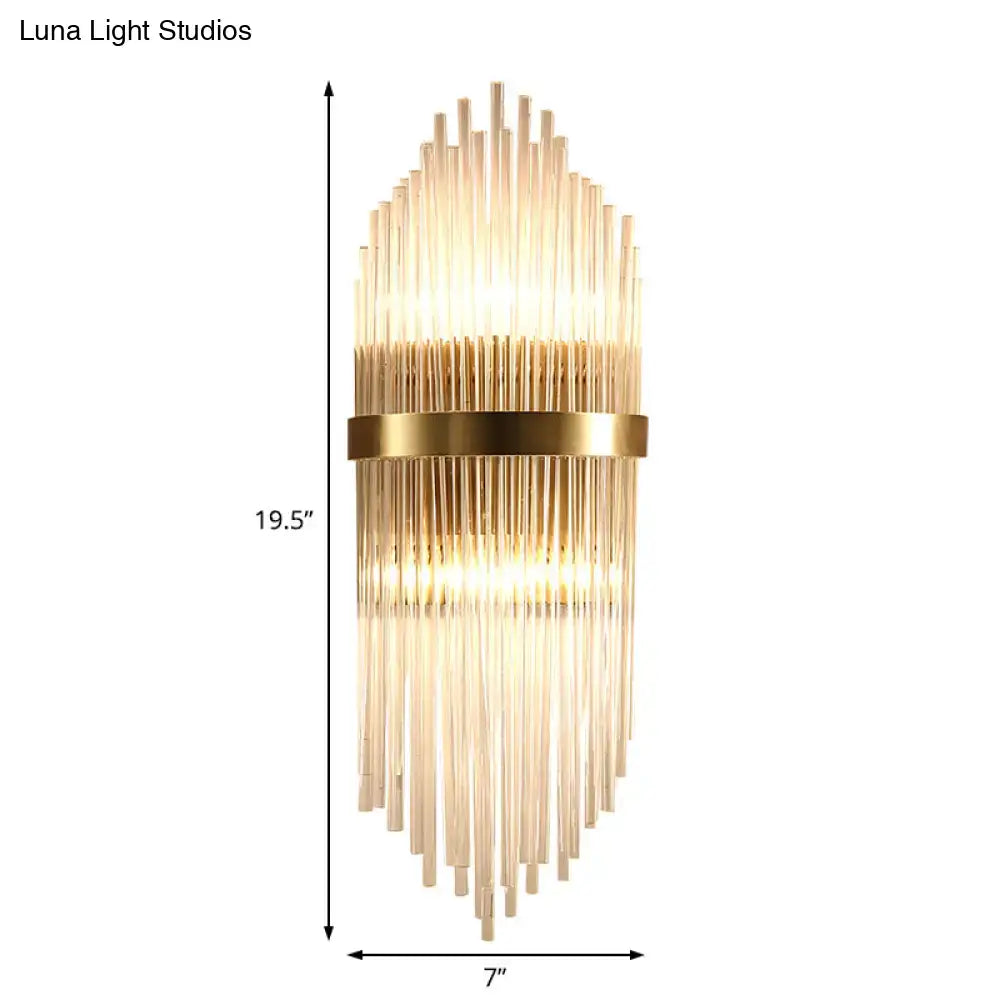 Modern brass fluted glass shade wall sconce with gold tones and direct wired electric design for bedroom lighting
