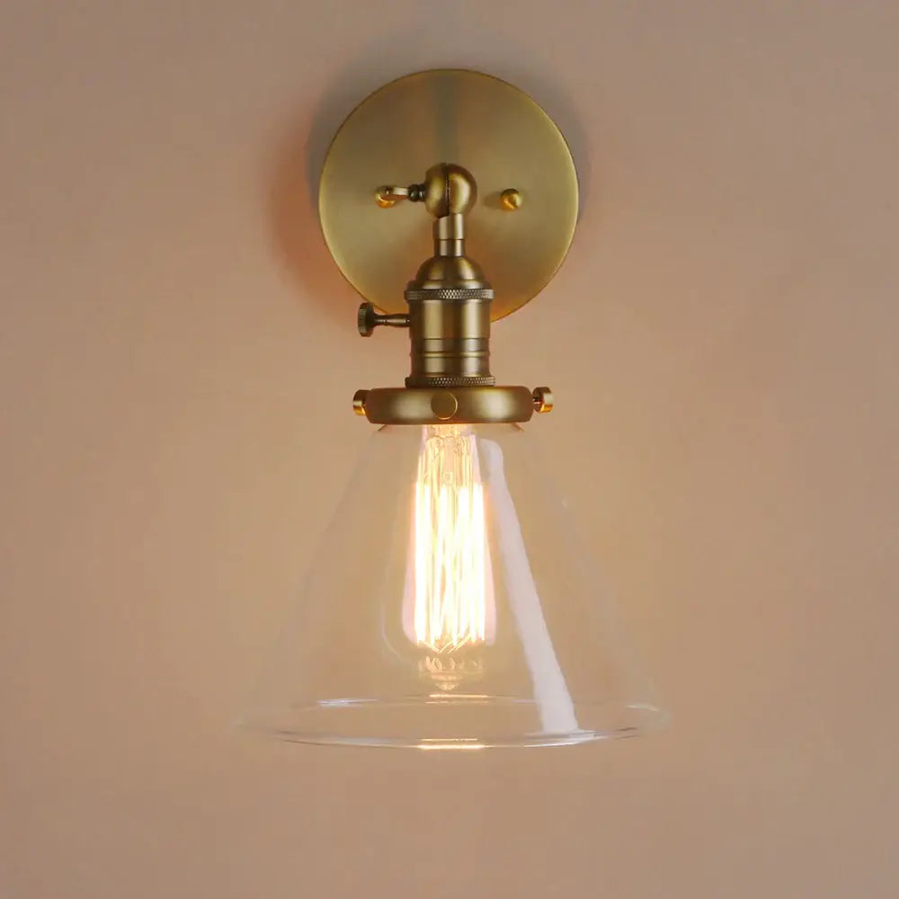 Modern brass funnel glass wall lamp with clear glass shade and exposed filament bulb for bedroom lighting decorbites funnel glass