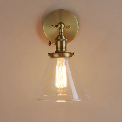 Modern brass funnel glass wall lamp with clear glass shade and exposed filament bulb for bedroom lighting decorbites funnel glass
