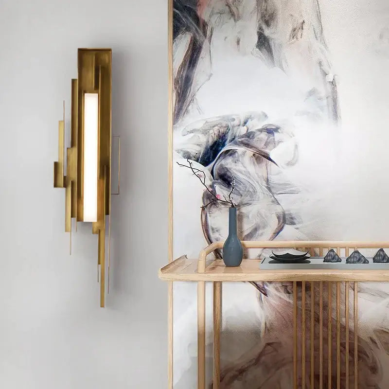 Modern brass elegant wall lamp with gold-toned layered rectangular panels and vertical illuminated light strip for living room