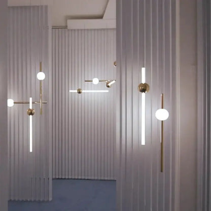 Modern brass glass pendant lights with gold metal frames and frosted glass spheres for dining room ambiance