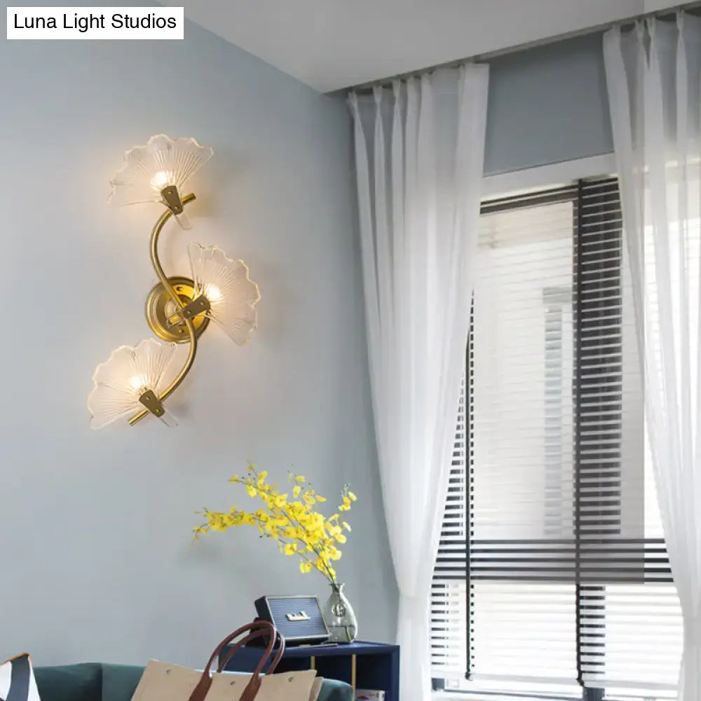 Modern brass ginkgo leaves wall light with gold-toned metal and three translucent fan-shaped glass shades for bedroom use