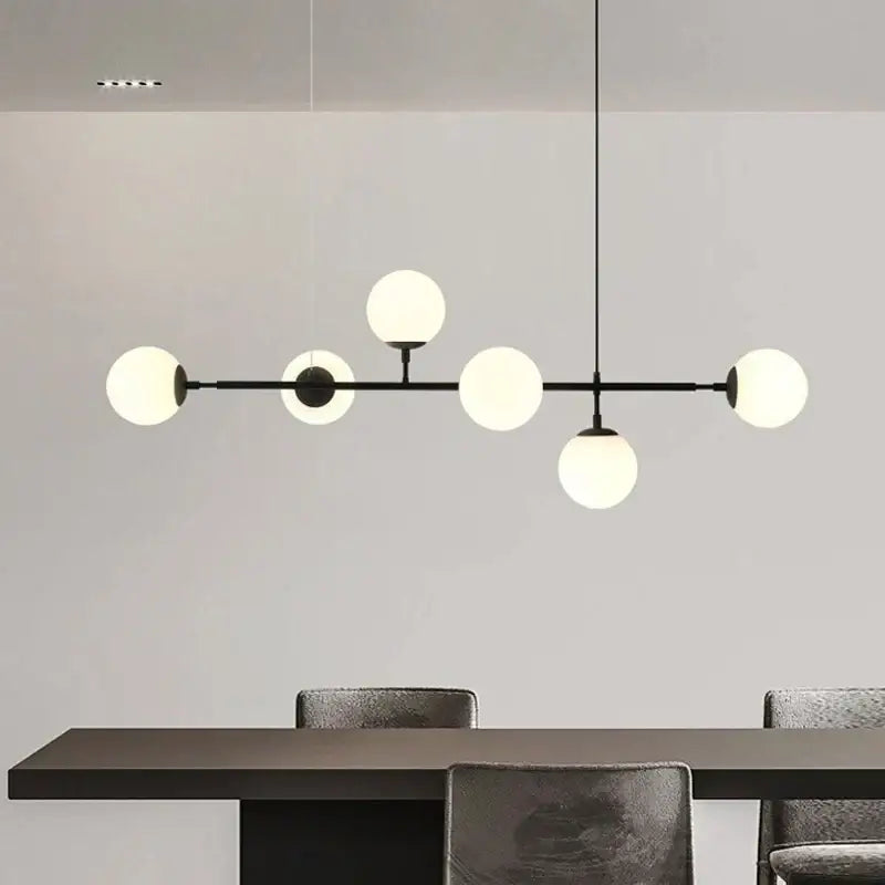 Modern black metal chandelier with six frosted glass globes featuring brass glass ball accents for living room decorbites brass glass